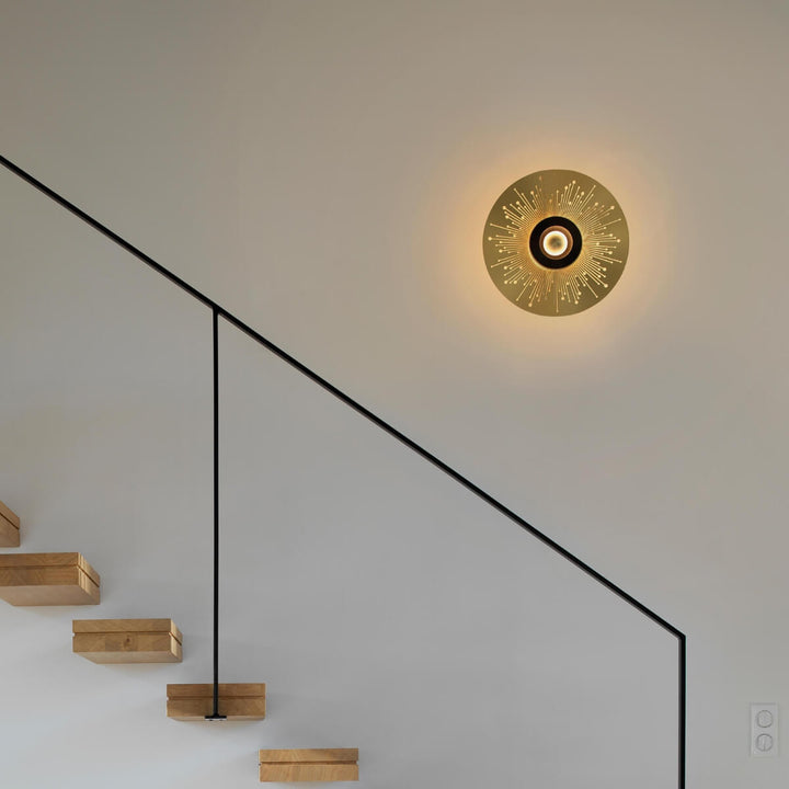 Sun and moon wall light by Eclipse Home beside stair wall, modern lighting for stylish interiors