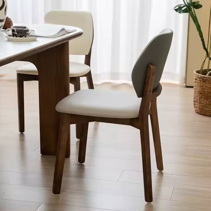 Angled hero view of Valora walnut dining chair showcasing wooden frame and cushioned seat in warm walnut finish