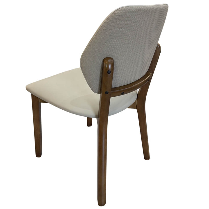 Side hero view of Valora walnut dining chair showcasing smooth wooden frame and ergonomic cushioned seat.