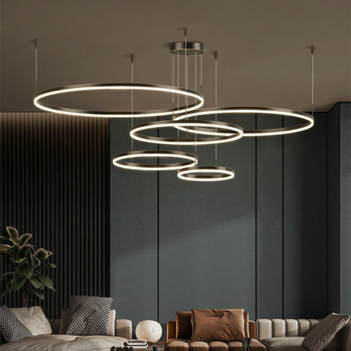 Vivid 5-ring circular chandelier light installed in a modern living room, offering elegant ambient lighting and contemporary design