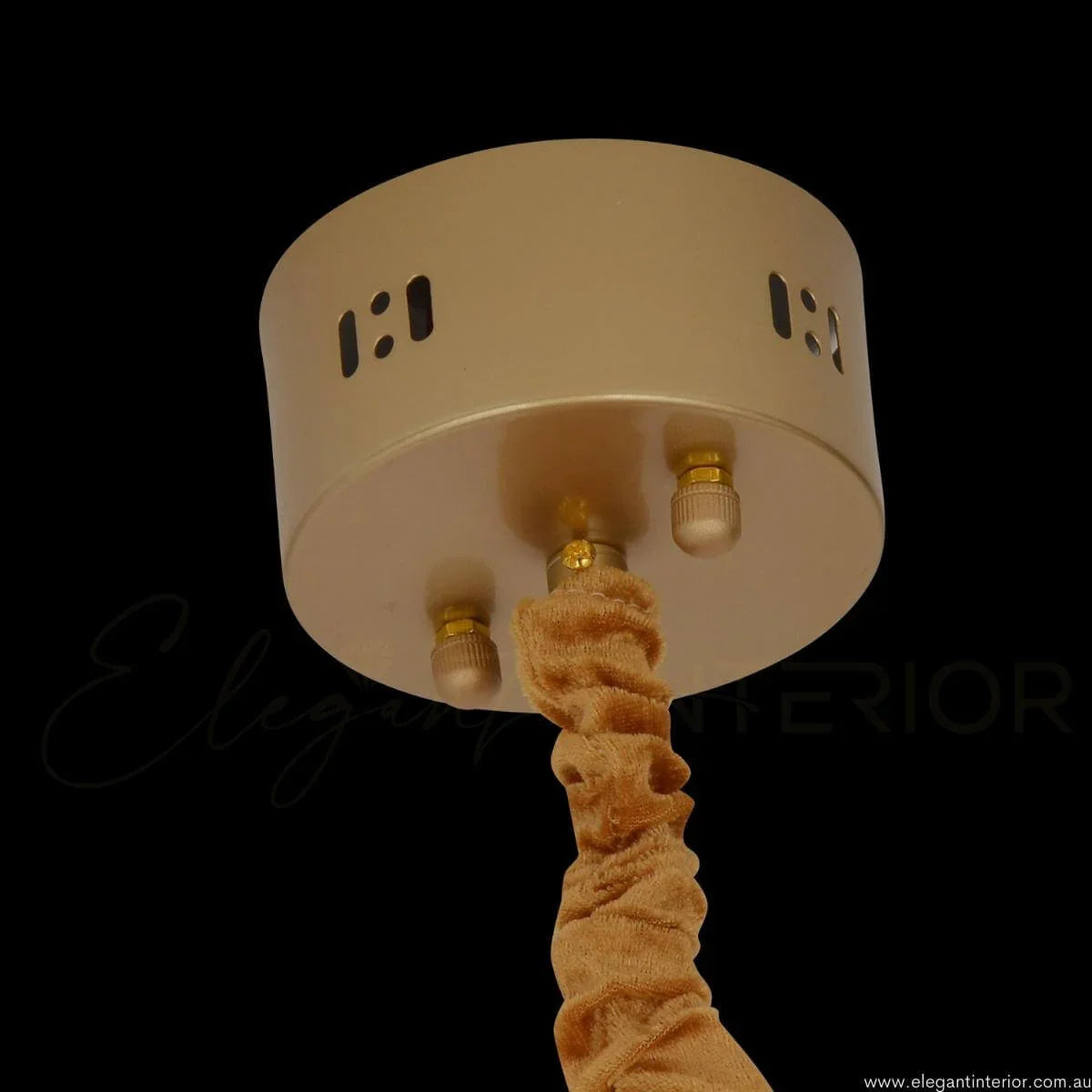 Detail view of AURA luxury modern pendant light with wall base in an elegant interior in Australia