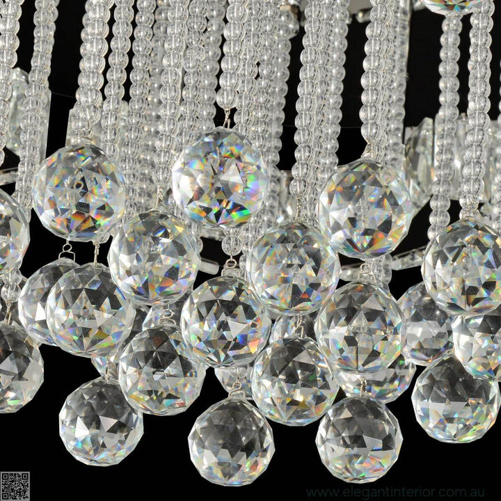 Close-up of elegant interior with crystal flush mount light and cloud-like design details