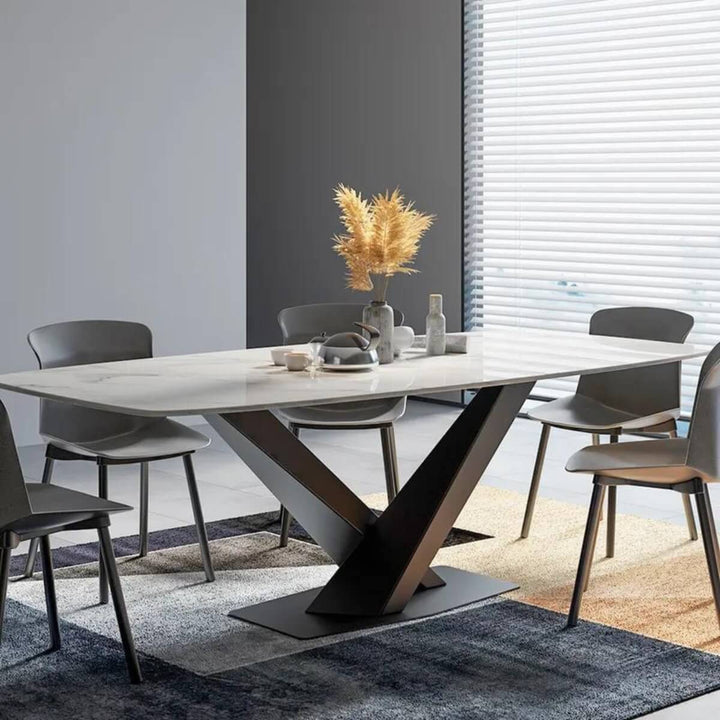 Side view of modern extendable marble dining table with X-base showcasing sleek and elegant design