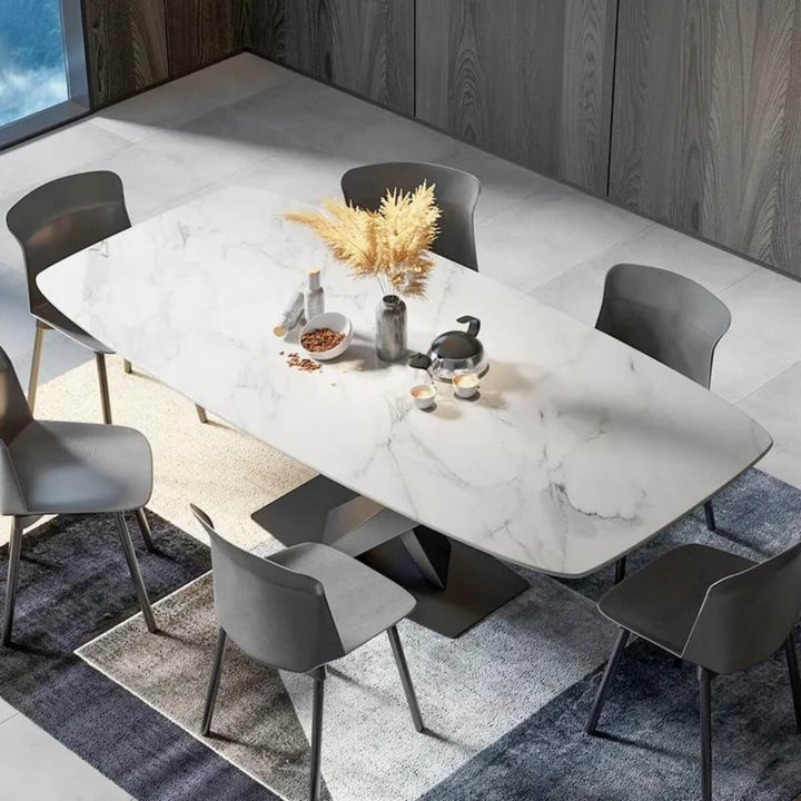 Top view of modern extendable marble dining table with X-base, showcasing smooth marble finish