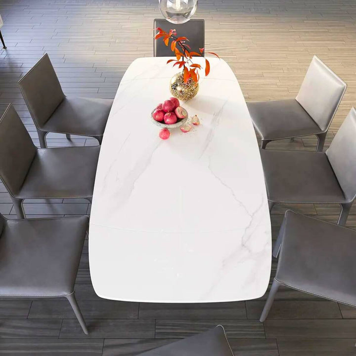 Top view of modern extendable marble dining table with X-base showcasing smooth marble surface