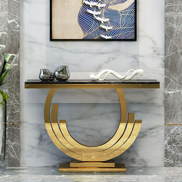 Front view of Lidia console table with black glass top and gold frame in an elegant interior setting