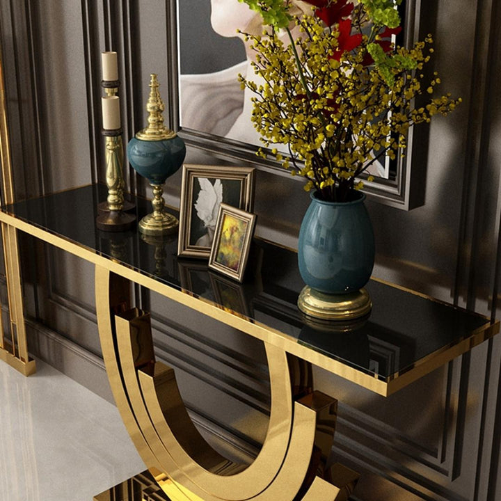 Top view of Lidia console table featuring black glass surface and gold frame in a stylish interior setting