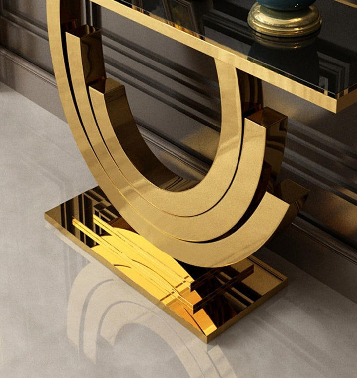 Close-up detail view of Lidia console table stand featuring gold frame and black glass design in a stylish interior setting