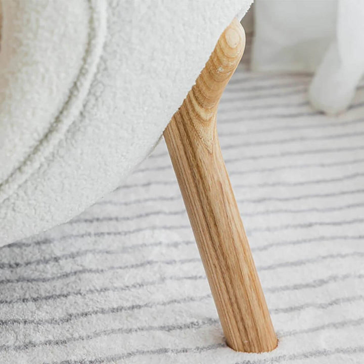 Detail view of lamb wool accent armchair’s wooden base stand in Australia showcasing craftsmanship
