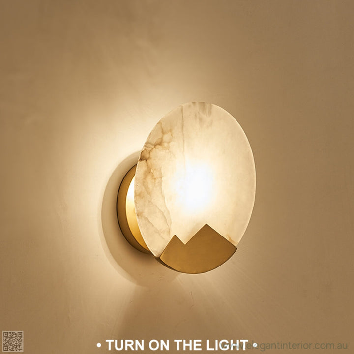 Marmar wall light side view with light on, highlighting warm glow and elegant marble design