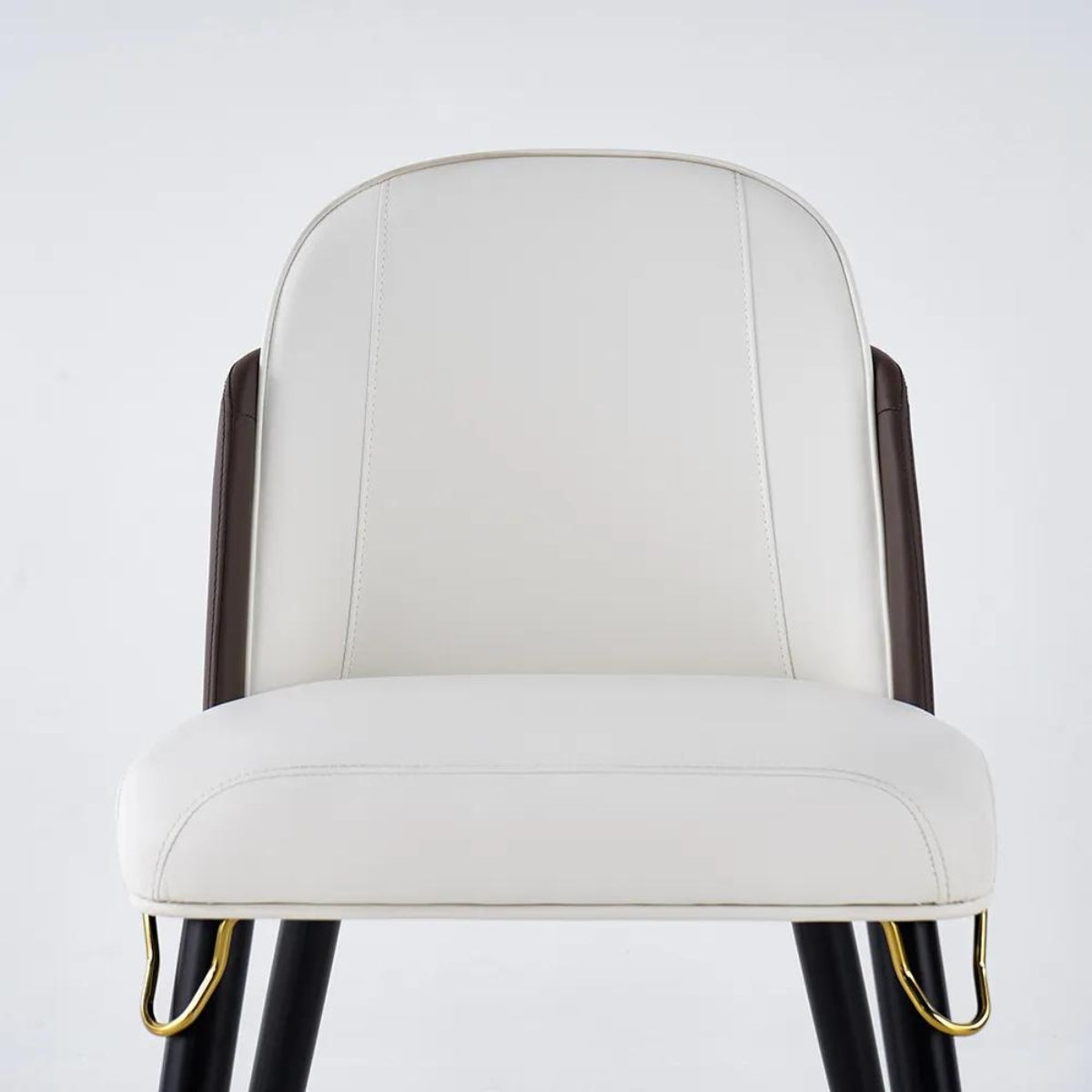 Detail view of modern beige and black dining room chairs showcasing texture and design