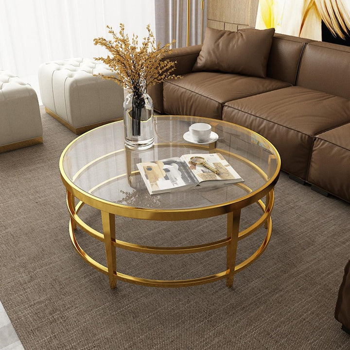 Rose luxury glass coffee table with gold base in elegant Australian interior – stylish design combining sleek glass and polished gold accents