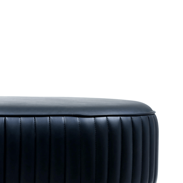 Detail view of Shell leather oval bench with golden half-moon base, highlighting texture and finish