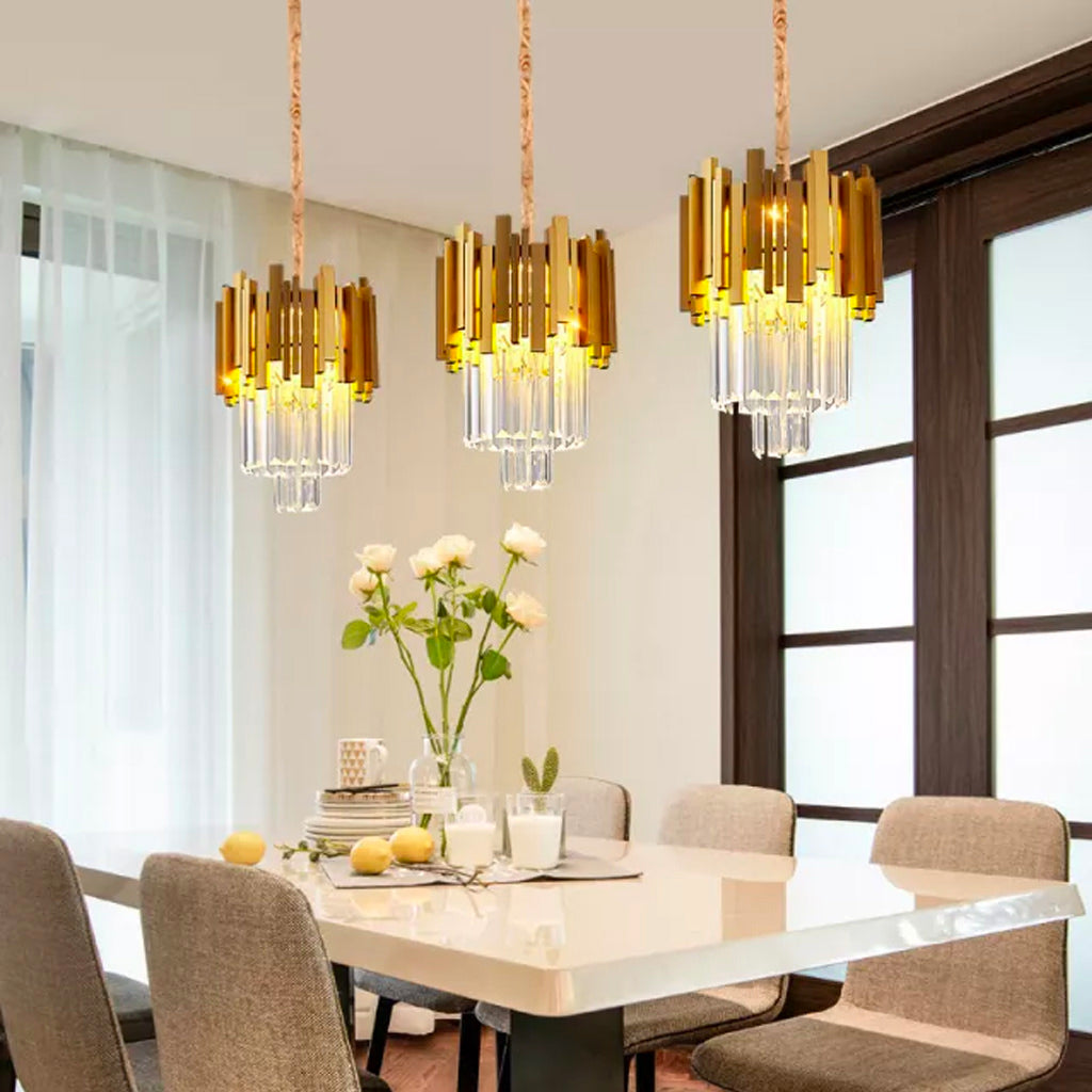  TARA 3Pc gold ceiling fixture hanging above dining table in elegant interior setting