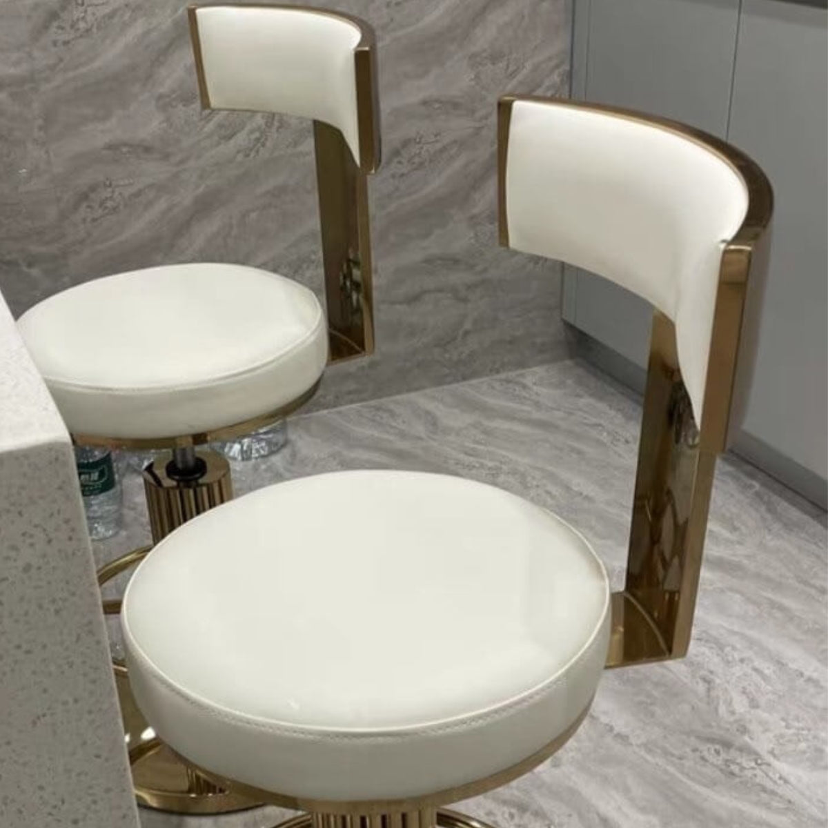 Side detail view of Tina luxury bar stool with gold finish in elegant Australian interior – showcasing polished frame and cushioned seat