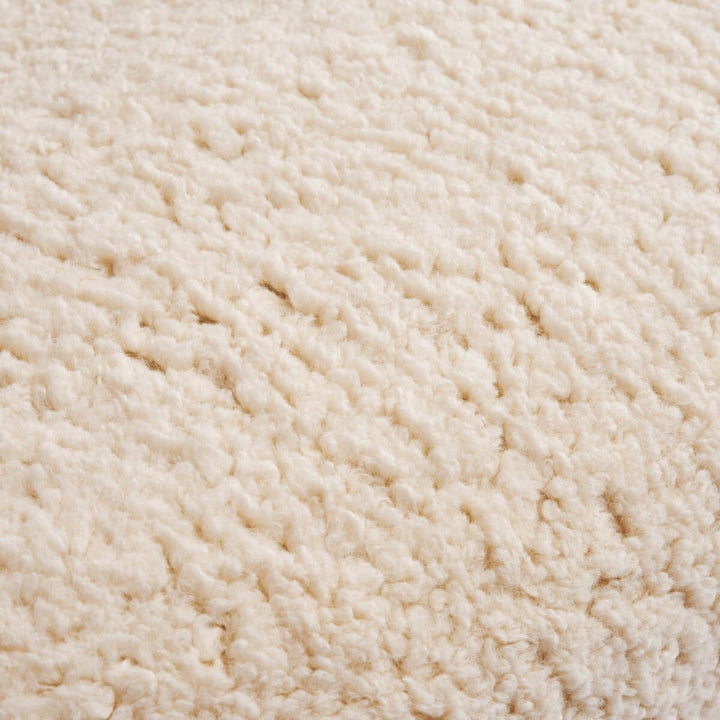 Detail view of cushion on wool accent armchair in Australia showcasing plush comfort