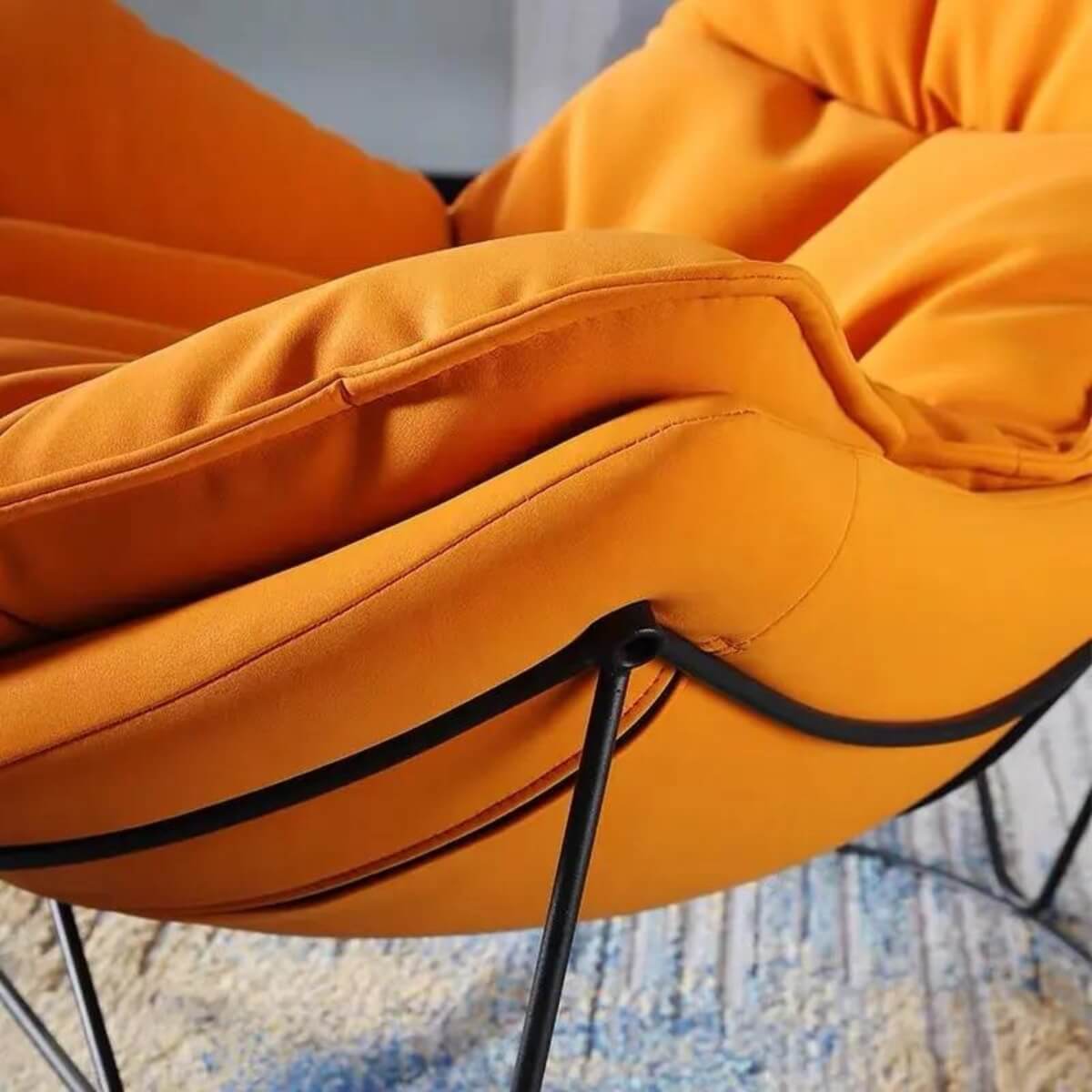 Front detail view of popular comfortable Italian upholstered soft lounge chair – close-up of plush cushions and fabric texture